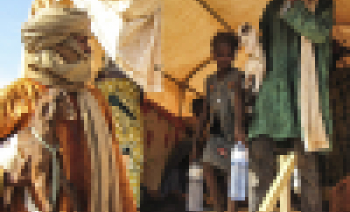 A family disembarks from a truck in Burkina Faso
